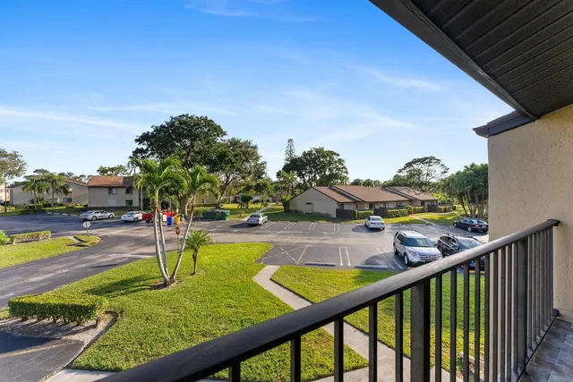 a view of a hallway with wooden floor and entryway