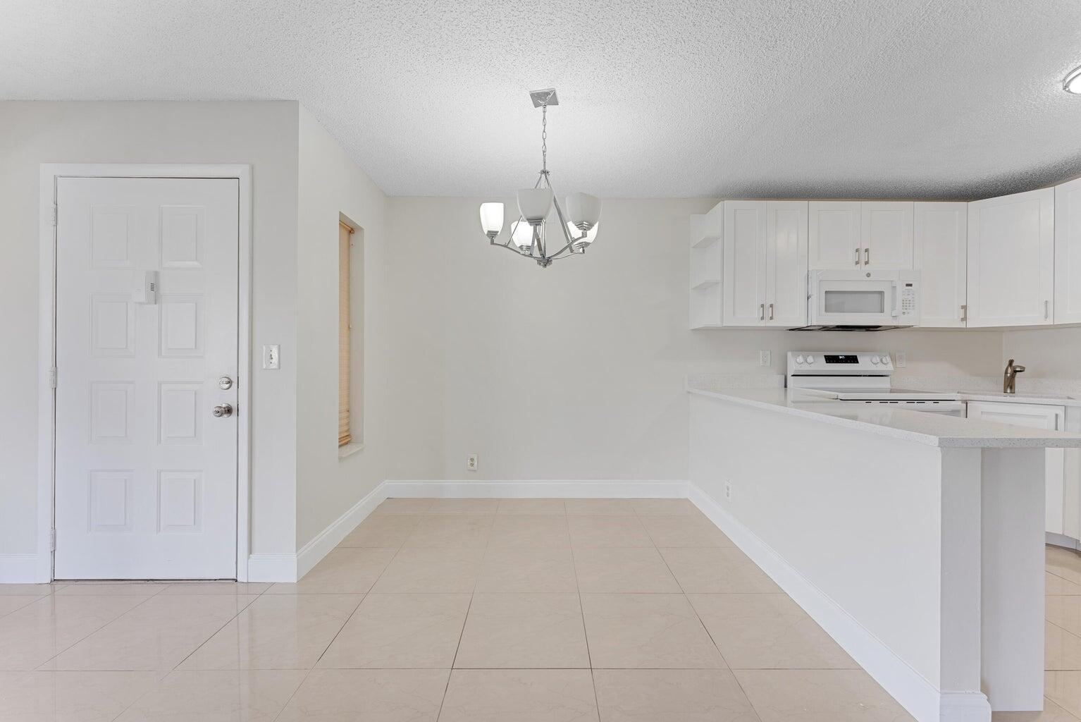 537 Shady Pine Way Greenacres, FL 33415 - Photo 5 of 21 a view of kitchen with cabinets and window