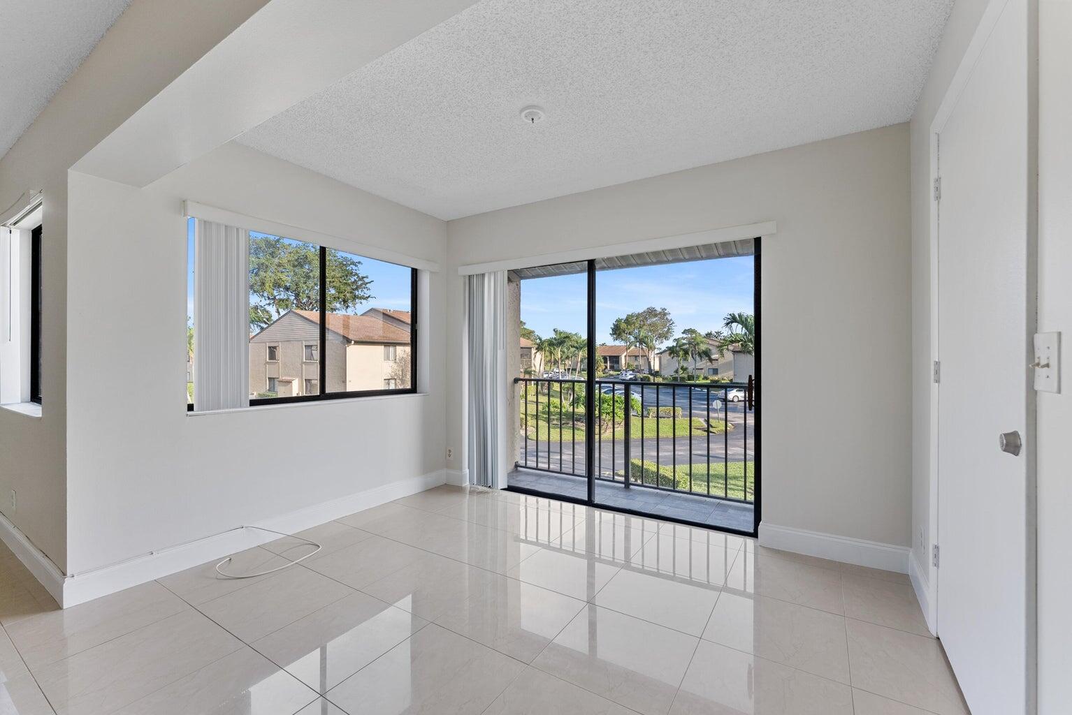 537 Shady Pine Way Greenacres, FL 33415 - Photo 7 of 21 a view of an empty room with glass door