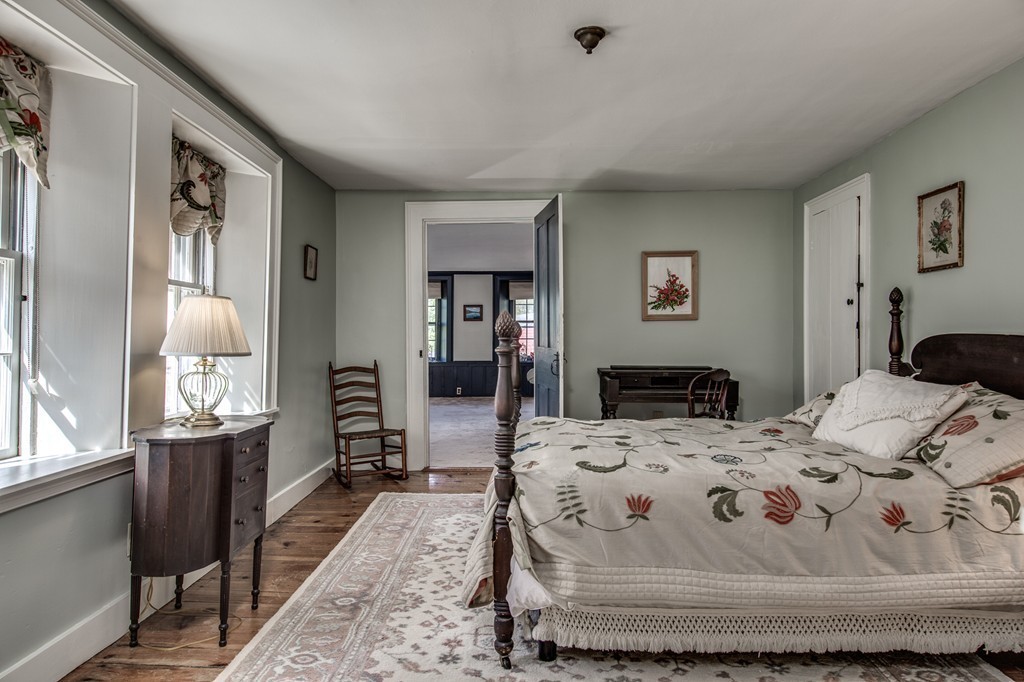 5 East Main Street Hopkinton, MA 01748 - Photo 12 of 20 a bedroom with a bed and wooden floor