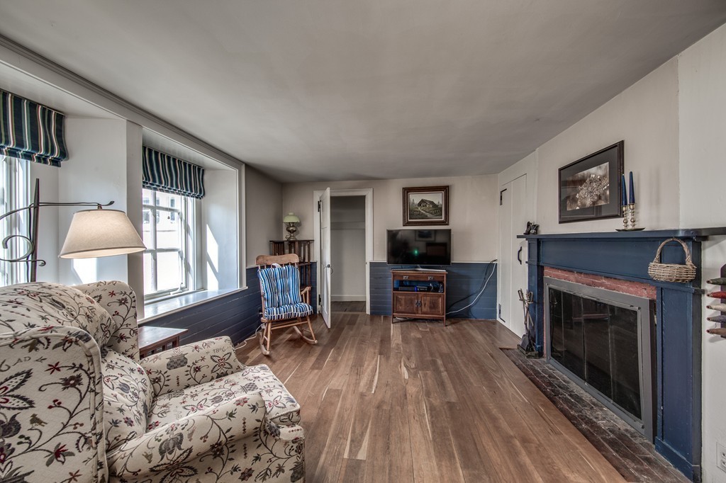 5 East Main Street Hopkinton, MA 01748 - Photo 17 of 20 a living room with furniture a fireplace and a flat screen tv