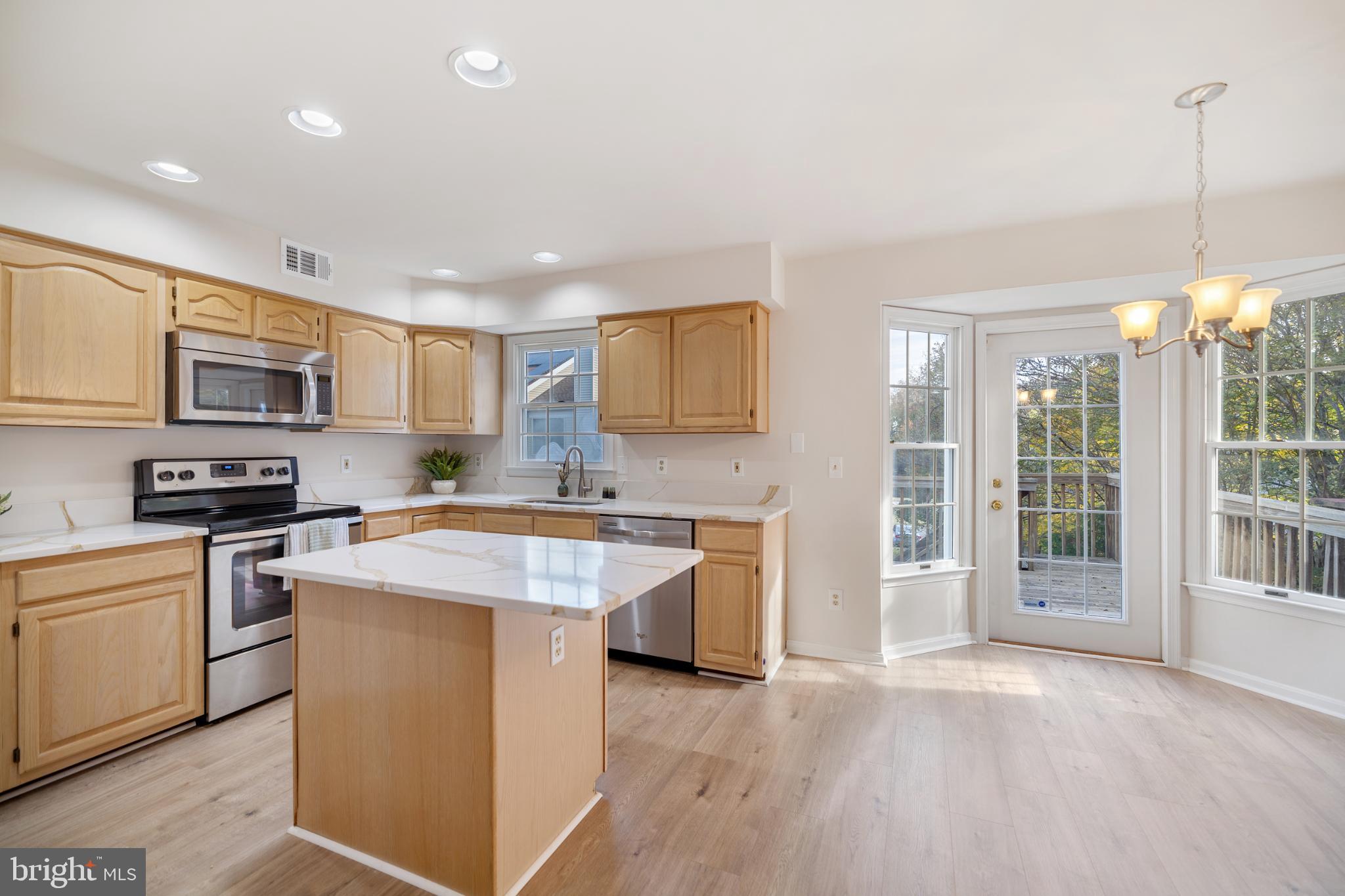 268 St Michaels Circle Odenton, MD 21113 - Photo 11 of 42 a kitchen with stainless steel appliances granite countertop a stove top oven a sink dishwasher and a refrigerator with wooden floor