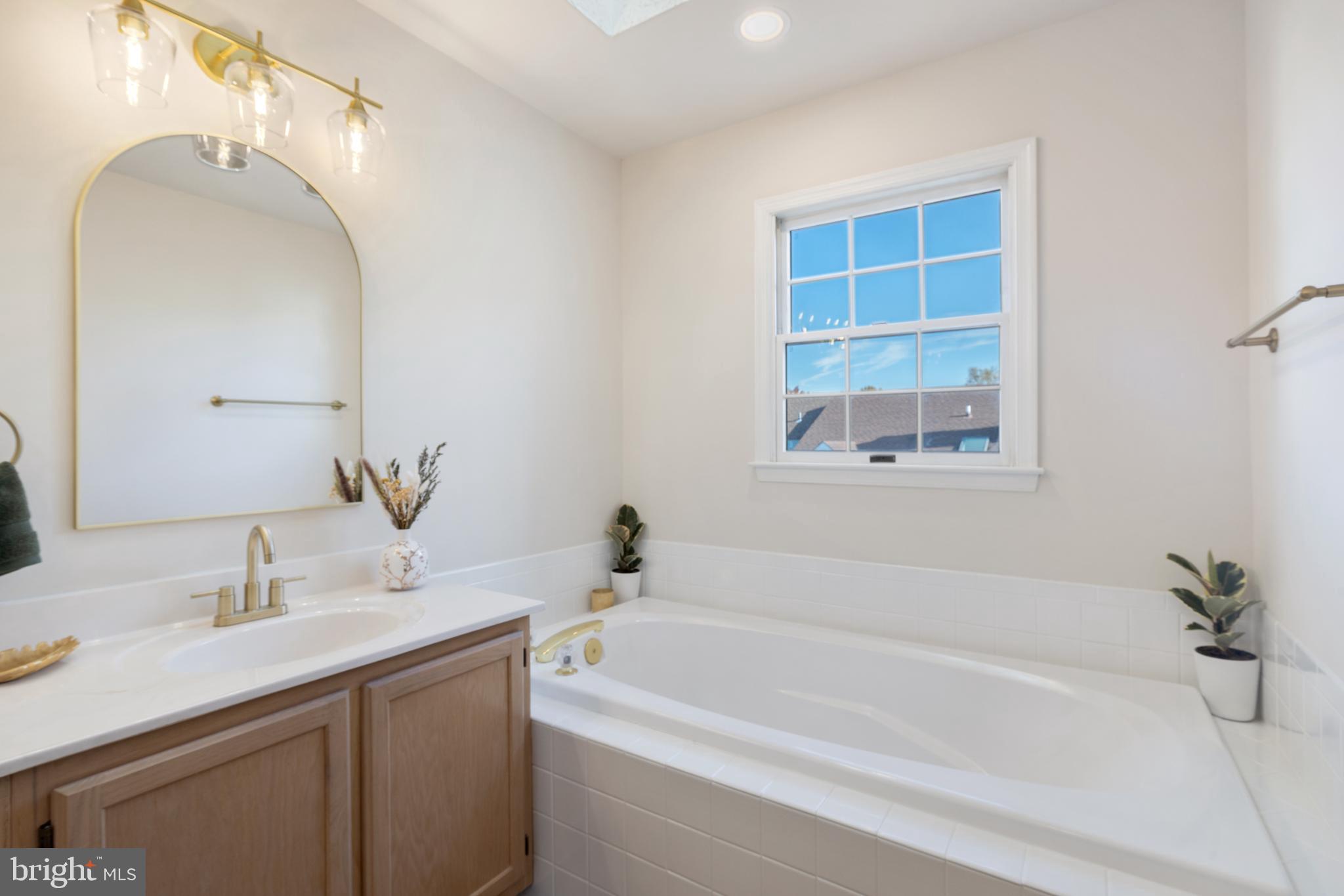 268 St Michaels Circle Odenton, MD 21113 - Photo 20 of 42 a bathroom with a tub sink and mirror