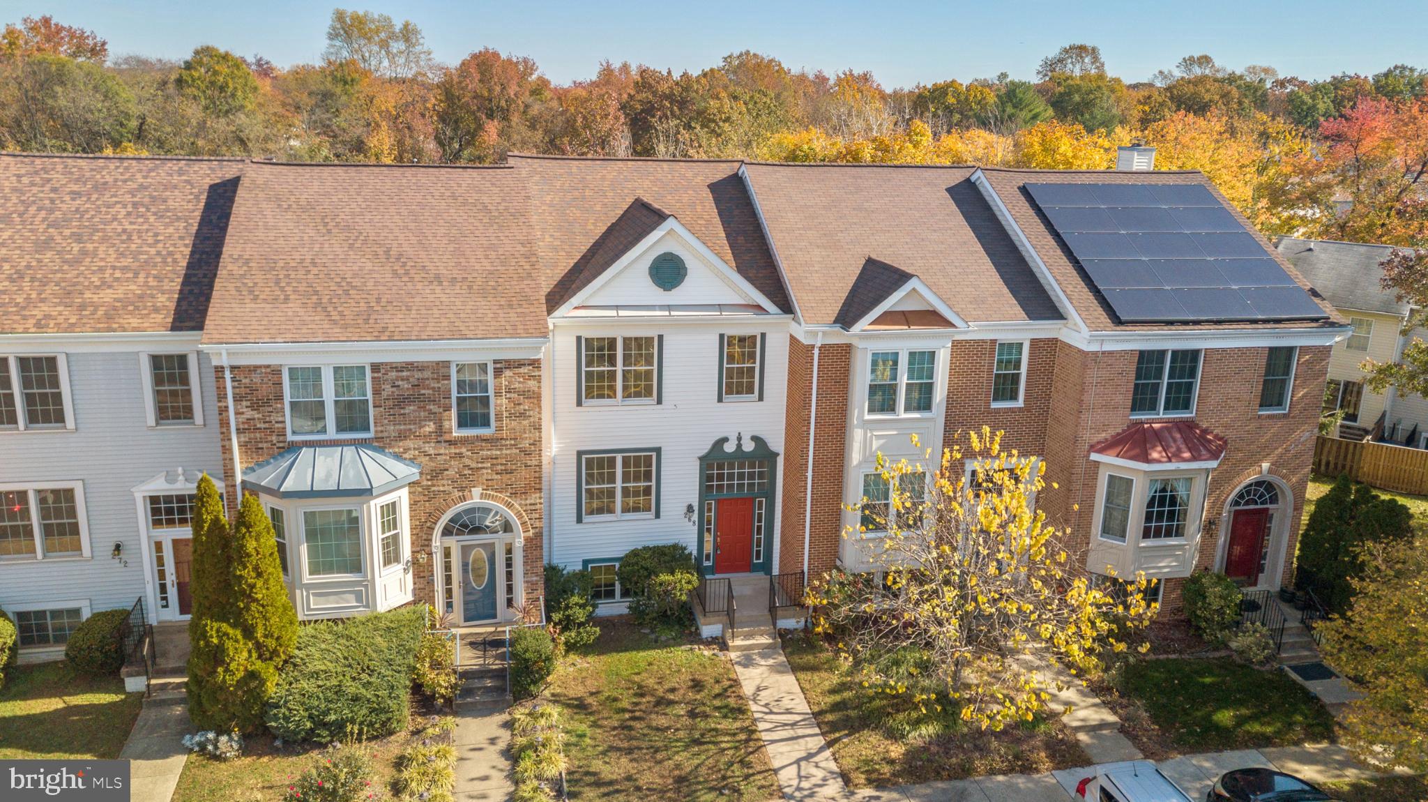 268 St Michaels Circle Odenton, MD 21113 - Photo 2 of 42 a aerial view of a house with a yard and table and chairs under an umbrella