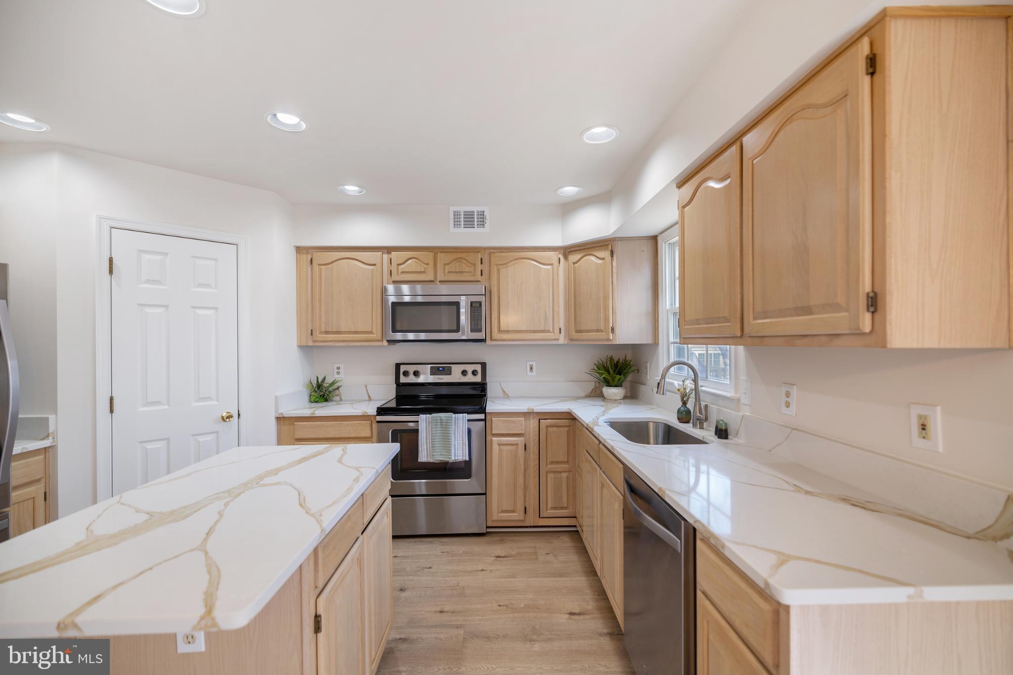 268 St Michaels Circle Odenton, MD 21113 - Photo 9 of 42 a kitchen with stainless steel appliances a sink a stove top oven a counter space and cabinets
