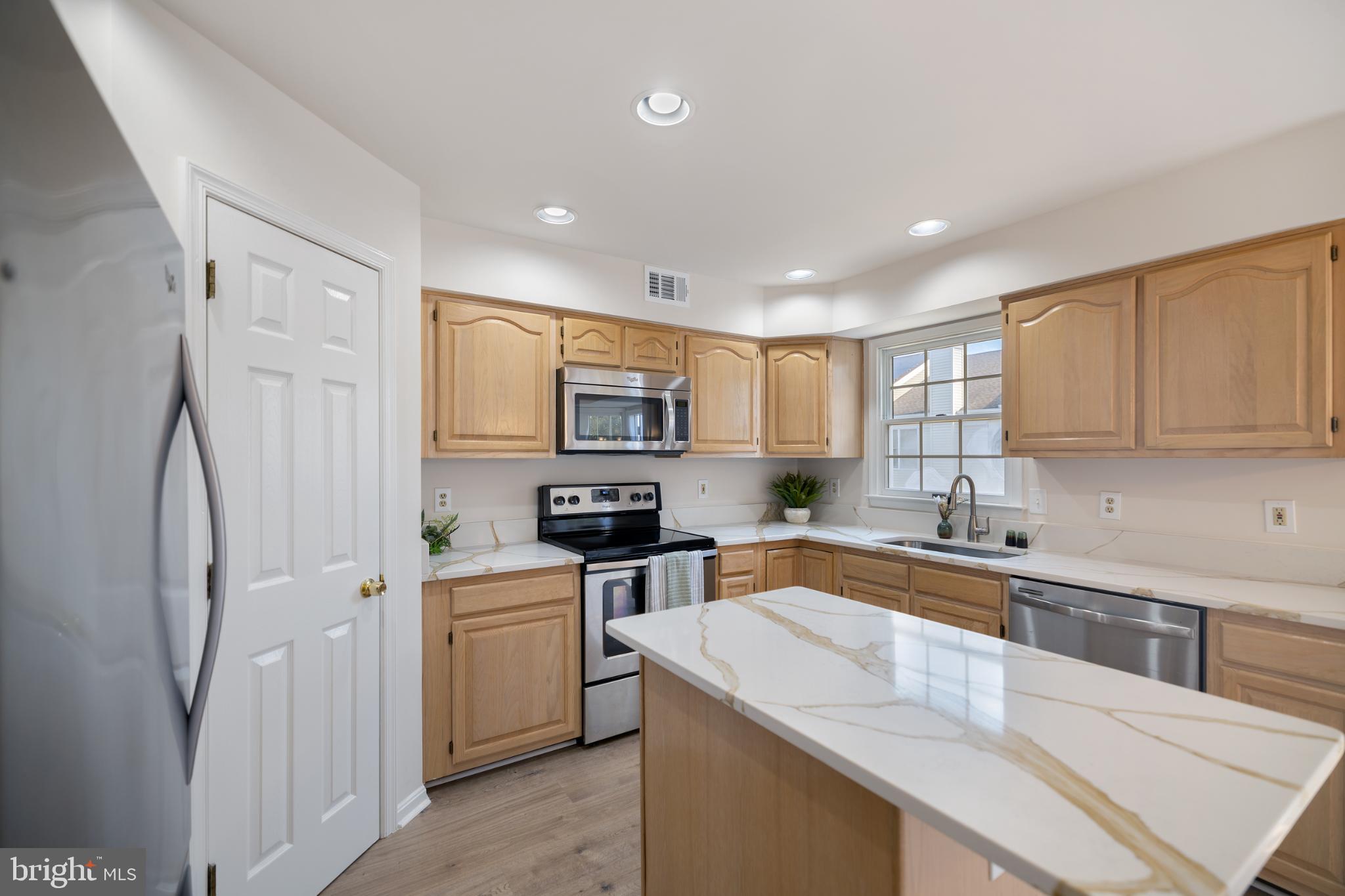 268 St Michaels Circle Odenton, MD 21113 - Photo 10 of 42 a kitchen with stainless steel appliances granite countertop a sink stove and refrigerator