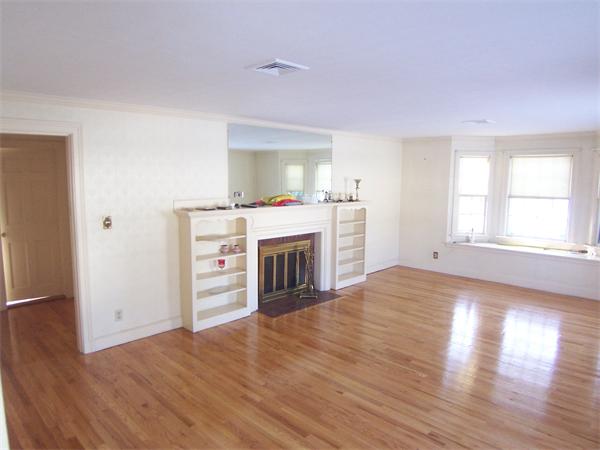 15 Hereford Road Marblehead, MA 01945 - Photo 1 of 1 an empty room with wooden floor fireplace and windows