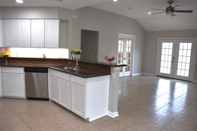 a view of an empty room with a fireplace and a window