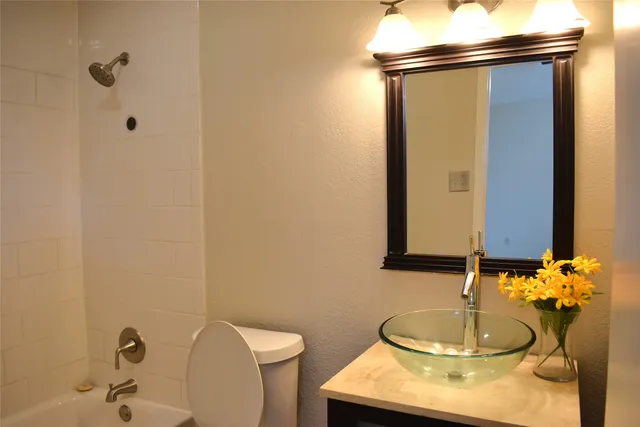 a bathroom with a sink vanity and a mirror