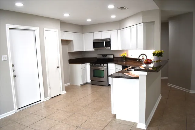 a kitchen with a stove a sink and a microwave