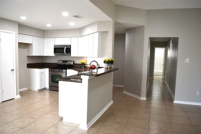 a kitchen with a sink and a white cabinets