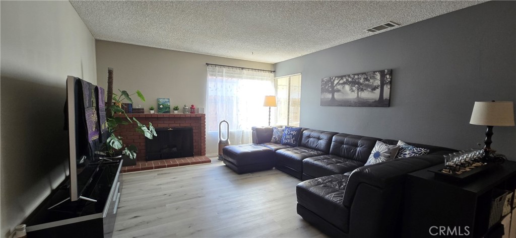 6830 Astoria Drive Riverside, CA 92503 - Photo 14 of 23 a living room with furniture gym equipment and a flat screen tv