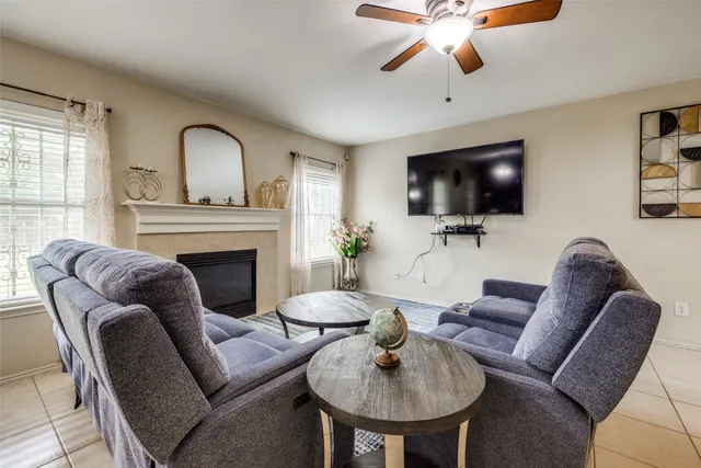 a living room with furniture a fireplace and a flat screen tv