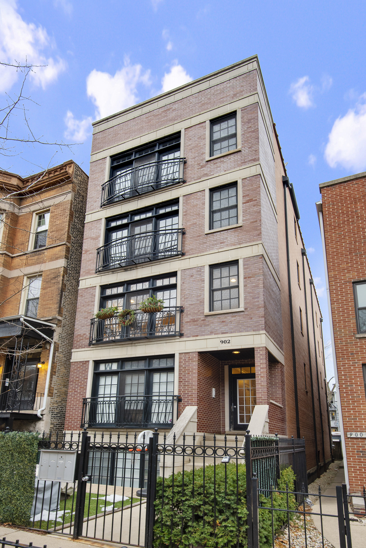 902 West Roscoe Street, Unit 2 Chicago, IL 60657 - Photo 1 of 14 a front view of a residential apartment building with a yard