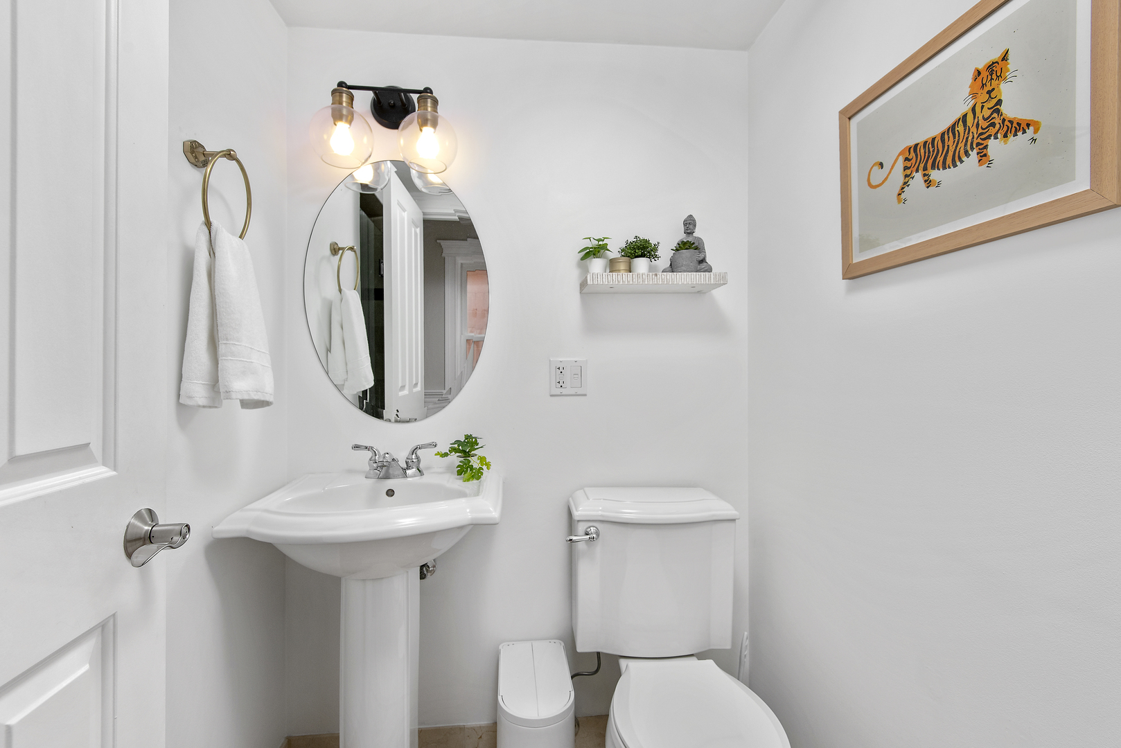 902 West Roscoe Street, Unit 2 Chicago, IL 60657 - Photo 13 of 14 a bathroom with a toilet sink and mirror