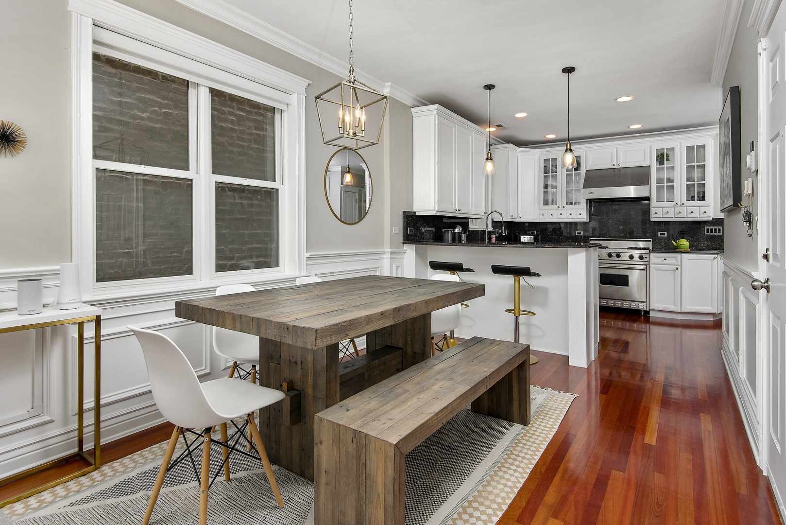 902 West Roscoe Street, Unit 2 Chicago, IL 60657 - Photo 6 of 14 a kitchen with stainless steel appliances granite countertop a stove top oven a sink dishwasher a dining table and chairs with wooden floor