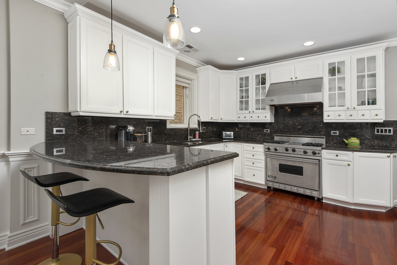 902 West Roscoe Street, Unit 2 Chicago, IL 60657 - Photo 7 of 14 a kitchen with stainless steel appliances granite countertop a stove a sink and a microwave
