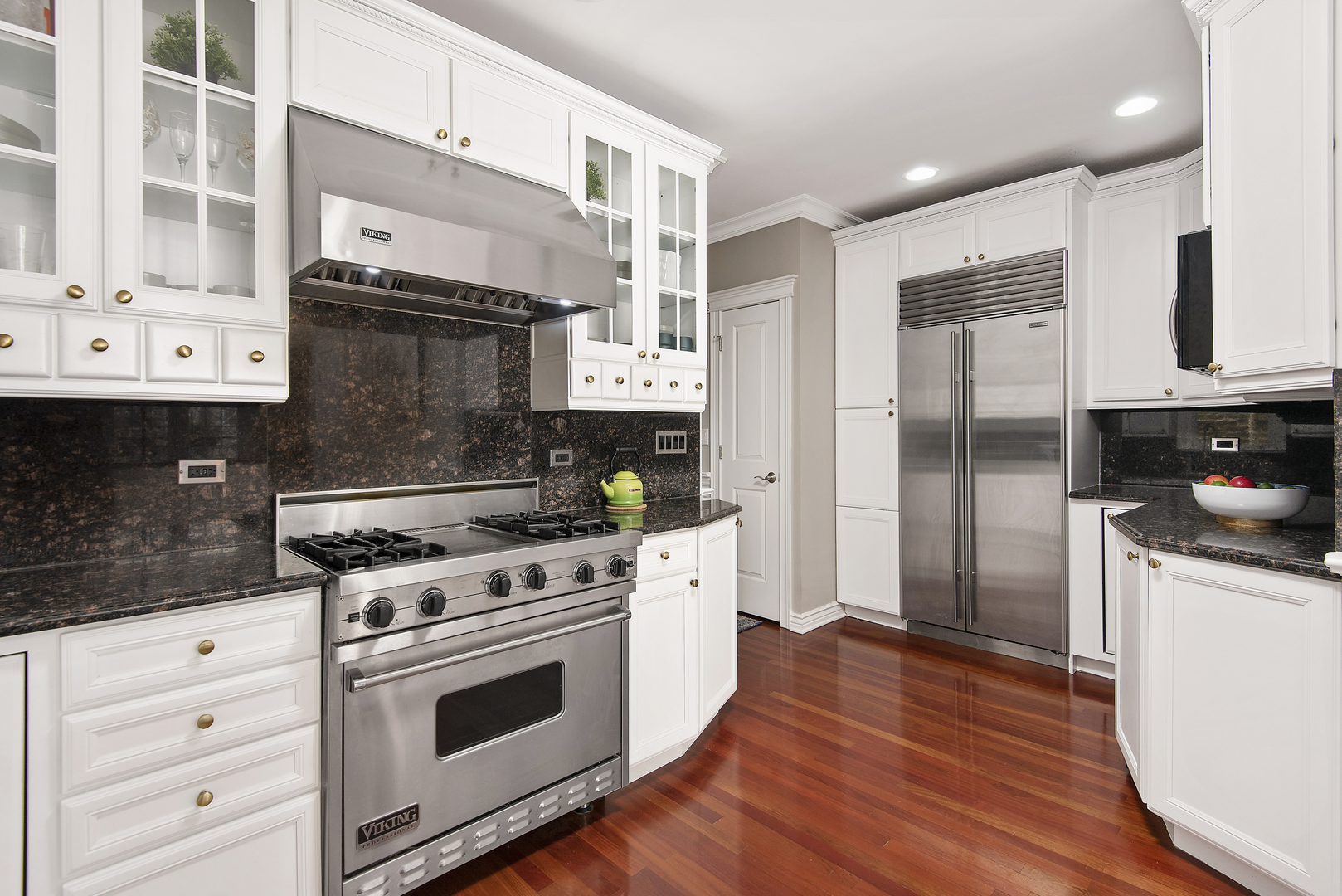 902 West Roscoe Street, Unit 2 Chicago, IL 60657 - Photo 8 of 14 a kitchen with stainless steel appliances white cabinets a stove a sink and a refrigerator
