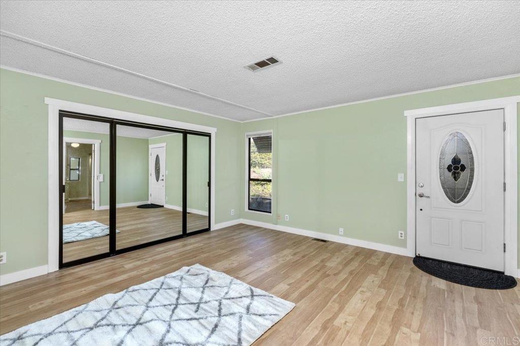 18218 Paradise Mountain Road, Unit SPC 206 Valley Center, CA 92082 - Photo 19 of 43 a view of a hallway with wooden floor and cabinet