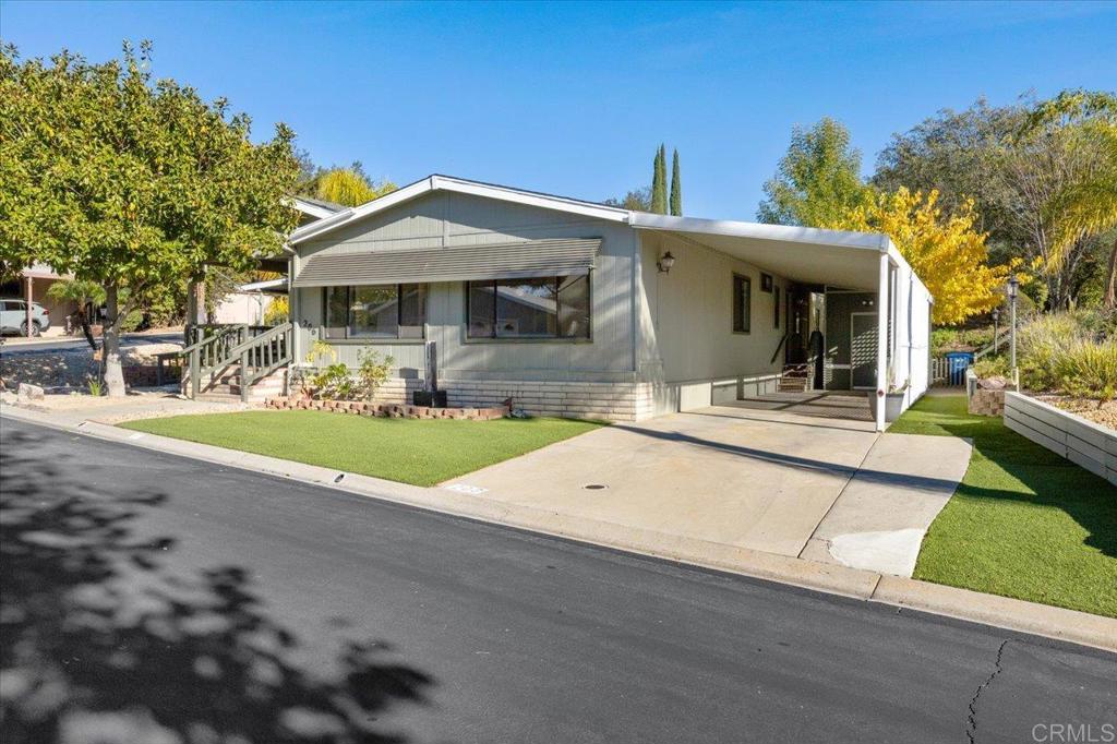 18218 Paradise Mountain Road, Unit SPC 206 Valley Center, CA 92082 - Photo 2 of 43 a view of a house with a outdoor space