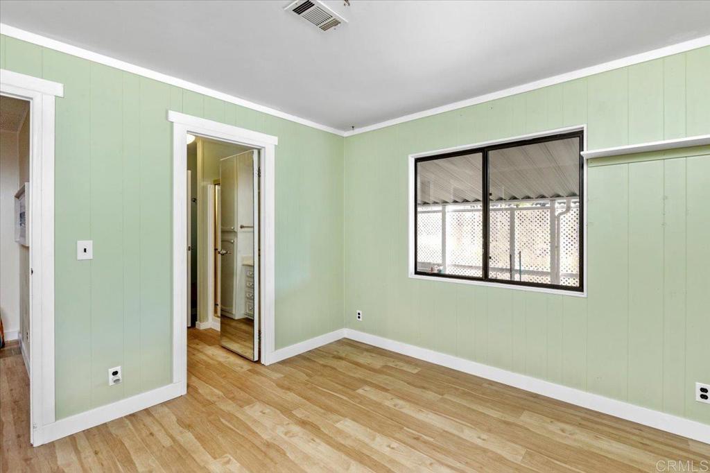 18218 Paradise Mountain Road, Unit SPC 206 Valley Center, CA 92082 - Photo 24 of 43 a view of an empty room with wooden floor and a window