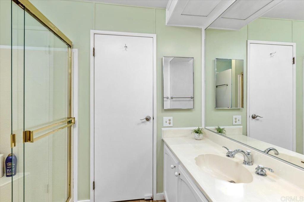 18218 Paradise Mountain Road, Unit SPC 206 Valley Center, CA 92082 - Photo 25 of 43 a bathroom with a sink and a mirror