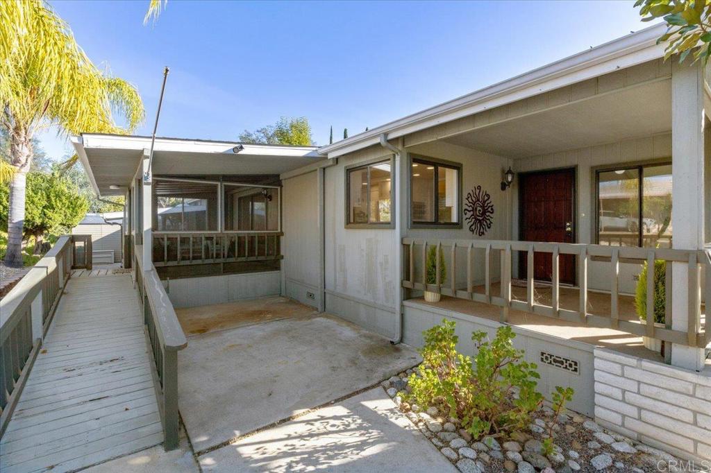 18218 Paradise Mountain Road, Unit SPC 206 Valley Center, CA 92082 - Photo 3 of 43 front view of a house with a porch