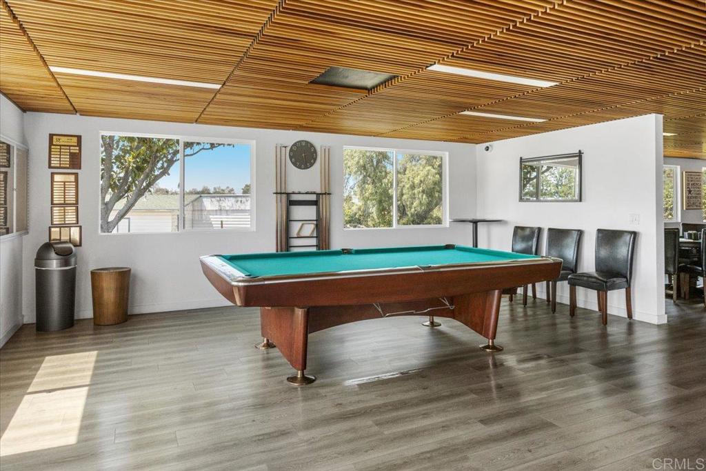 18218 Paradise Mountain Road, Unit SPC 206 Valley Center, CA 92082 - Photo 35 of 43 a room with wooden floors table and windows