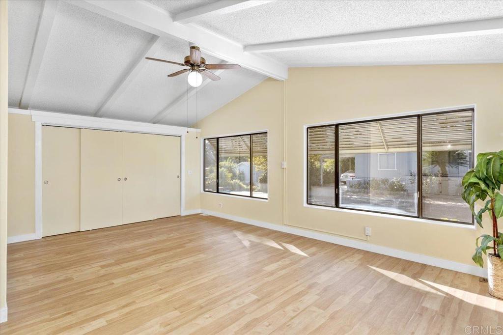 18218 Paradise Mountain Road, Unit SPC 206 Valley Center, CA 92082 - Photo 5 of 43 a view of an empty room with a window and wooden floor