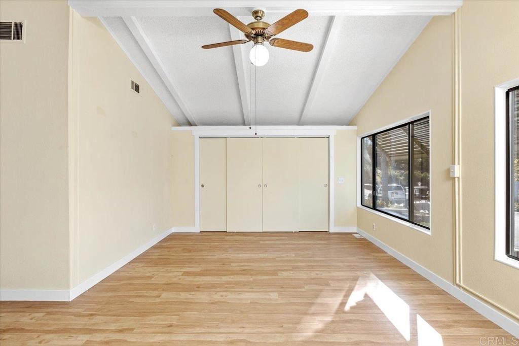 18218 Paradise Mountain Road, Unit SPC 206 Valley Center, CA 92082 - Photo 7 of 43 a view of a big room with wooden floor and windows in a room
