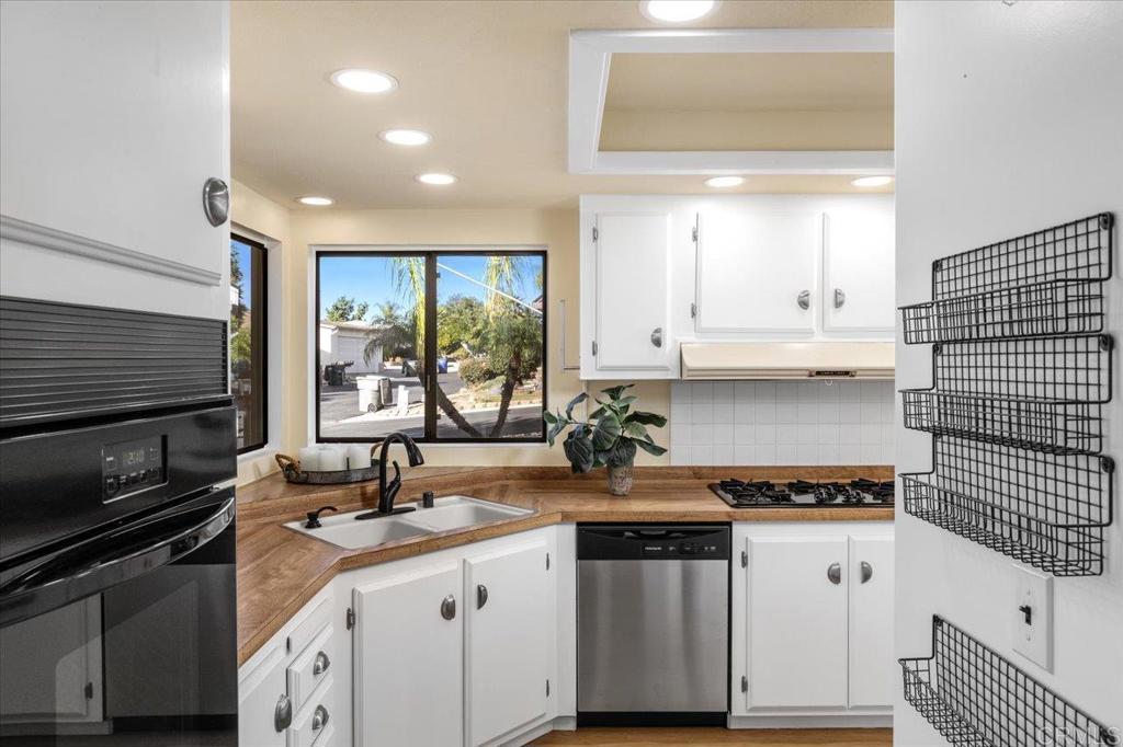 18218 Paradise Mountain Road, Unit SPC 206 Valley Center, CA 92082 - Photo 10 of 43 a kitchen with a sink stove and cabinets
