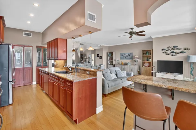 a living room with furniture a rug a window and a flat screen tv