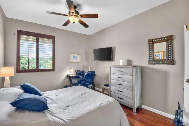 a bedroom with a chair and flat screen tv