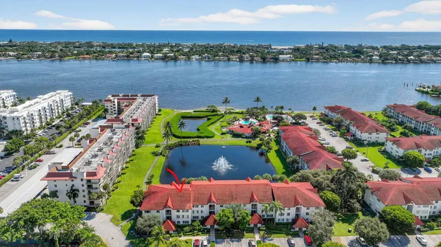an aerial view of lake and houses with outdoor space