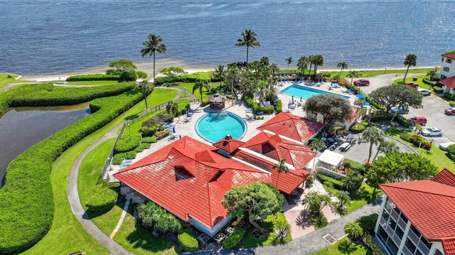an aerial view of lake and residential houses with outdoor space