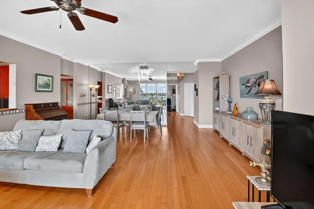 a living room with furniture and a wooden floor