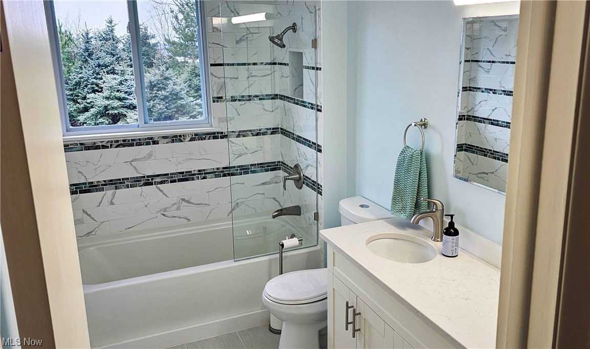 19755 Upper Terrace Road Euclid, OH 44117 - Photo 11 of 38 Full bathroom featuring tile floors, tiled shower / bath combo, toilet, and large vanity