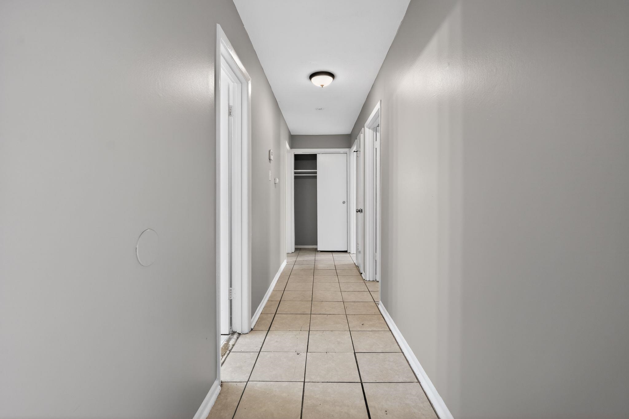 4828 Knight Arnold Road Memphis, TN 38118 - Photo 17 of 24 Hallway with baseboards and light tile patterned floors