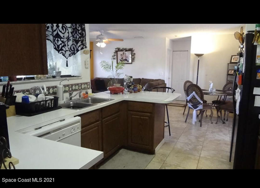 714 Seymour Road Northeast Palm Bay, FL 32905 - Photo 3 of 5 a kitchen with a sink and cabinets