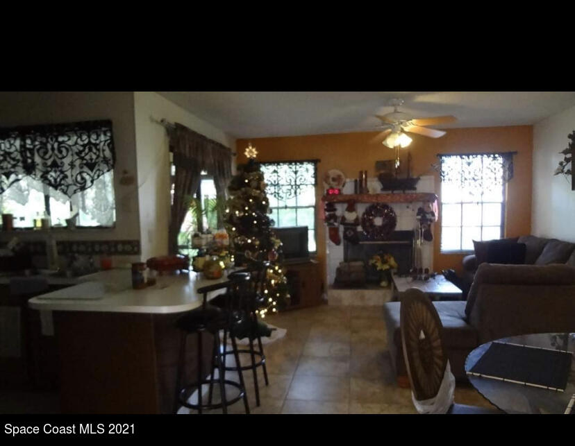 714 Seymour Road Northeast Palm Bay, FL 32905 - Photo 4 of 5 a living room with furniture and a large window