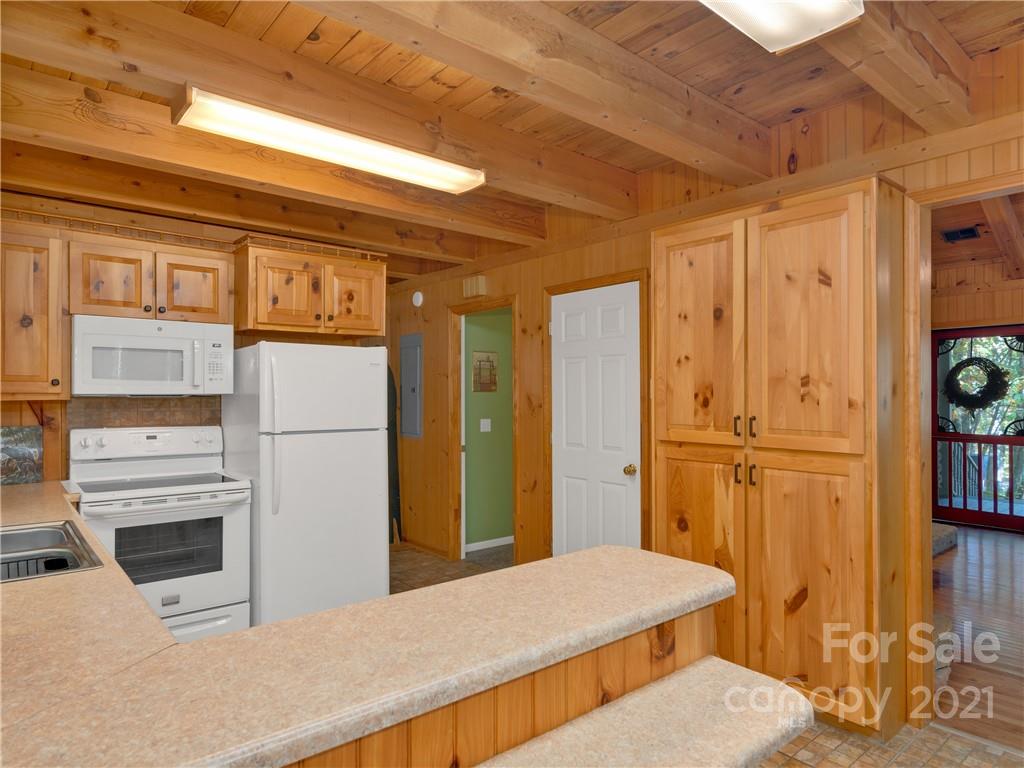 357 Reuben Branch Road Maggie Valley, NC 28751 - Photo 14 of 32 a kitchen with stainless steel appliances kitchen island sink refrigerator and stove