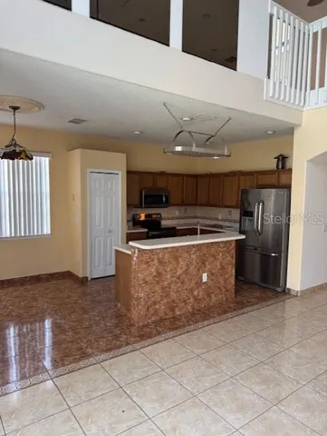 a kitchen with stainless steel appliances granite countertop a stove a sink and a microwave