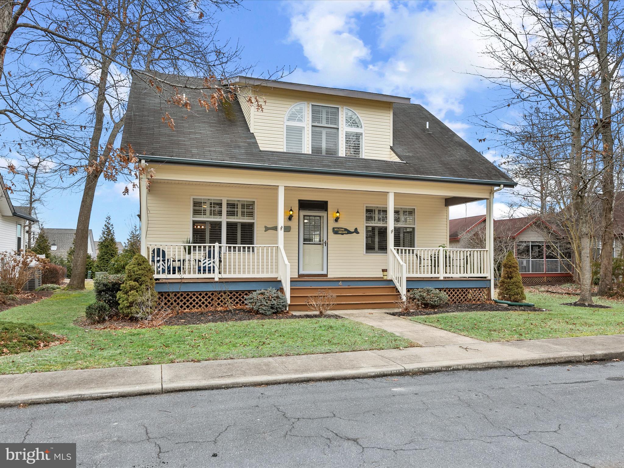a front view of a house with a yard and a garage