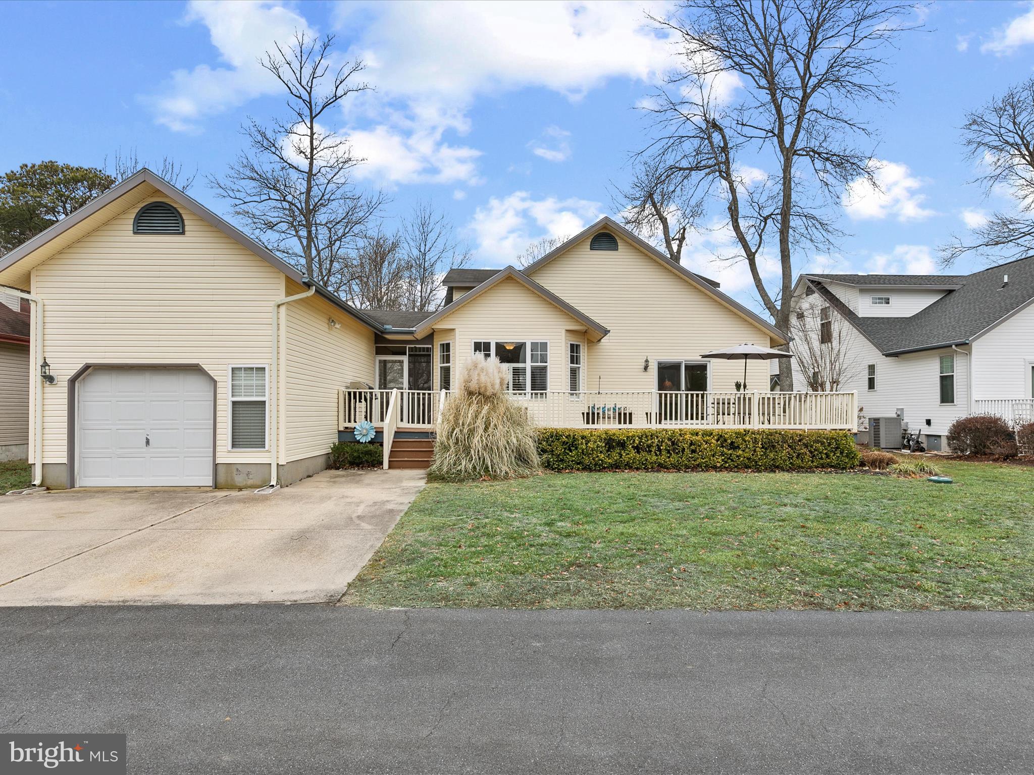 4 Cromwell Drive Ocean View, DE 19970 - Photo 46 of 59 a front view of a house with a garden and trees