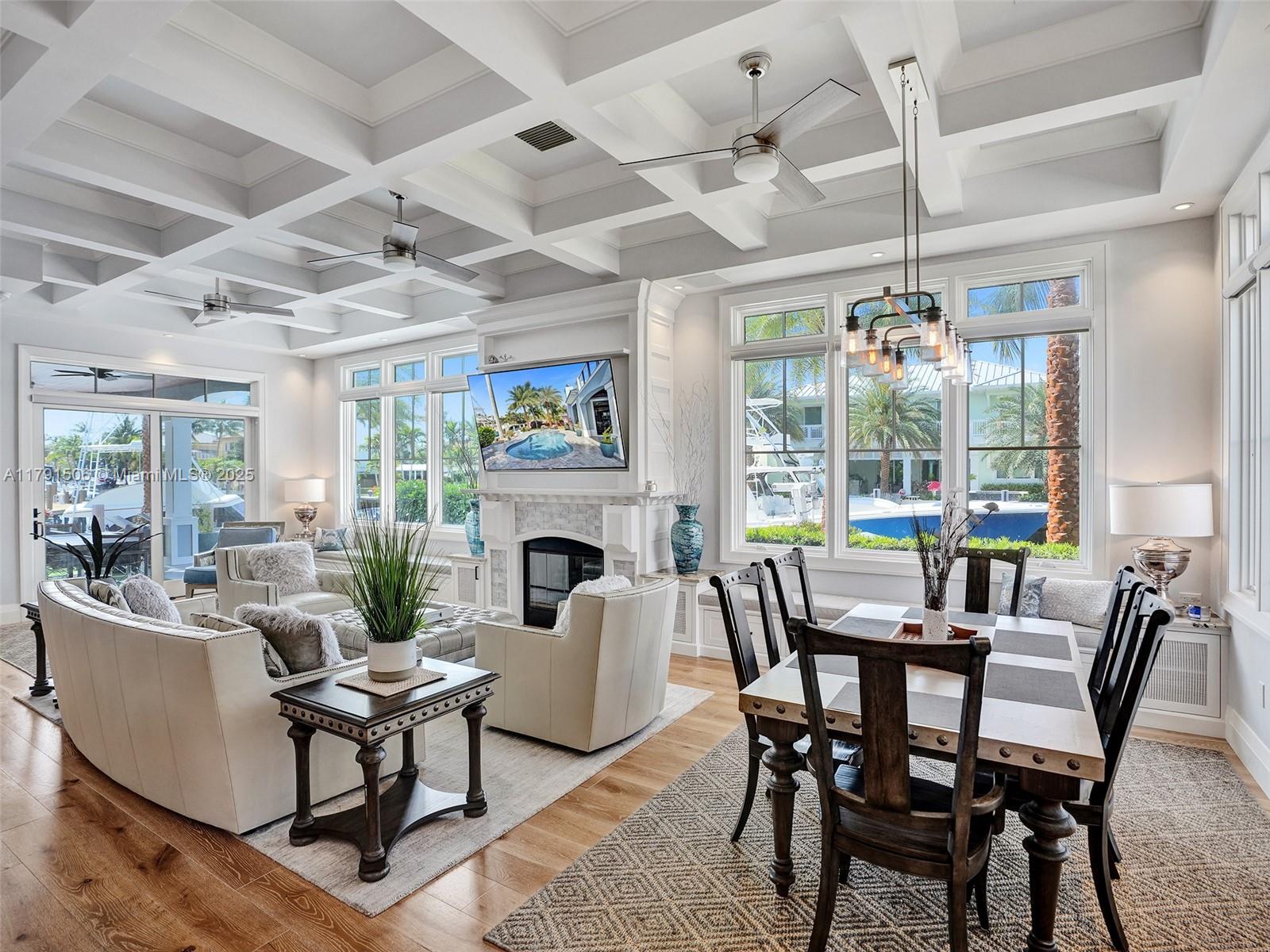 2340 Northeast 48th Street Lighthouse Point, FL 33064 - Photo 11 of 48 a dining room with furniture a fireplace and large windows