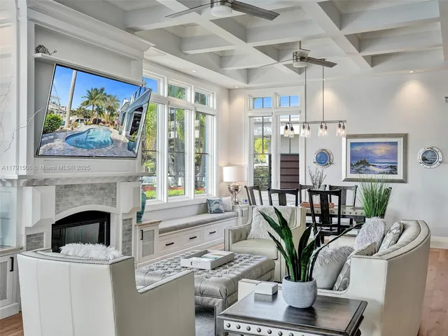 a living room with furniture a fireplace and a potted plant