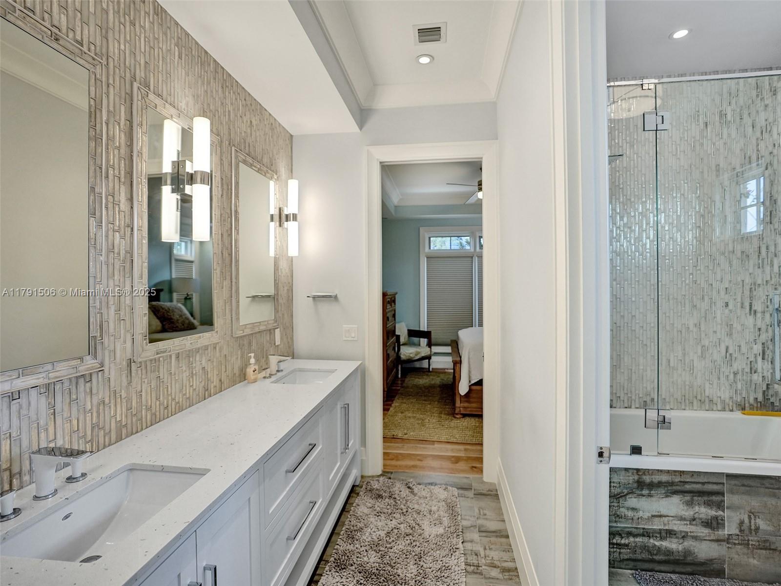 2340 Northeast 48th Street Lighthouse Point, FL 33064 - Photo 22 of 48 a spacious bathroom with a tub sink and mirror