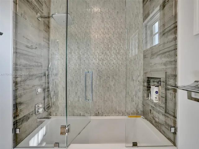 a bathroom with a bathtub and a shower