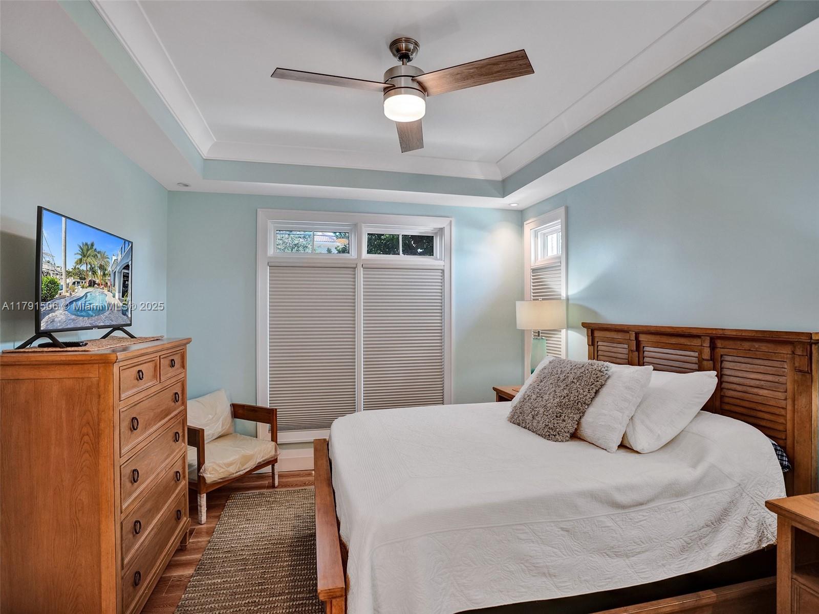 2340 Northeast 48th Street Lighthouse Point, FL 33064 - Photo 27 of 48 a bedroom with a bed and a chandelier