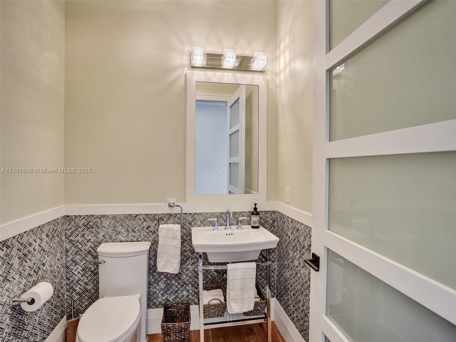 2340 Northeast 48th Street Lighthouse Point, FL 33064 - Photo 28 of 48 a bathroom with a toilet a sink and mirror